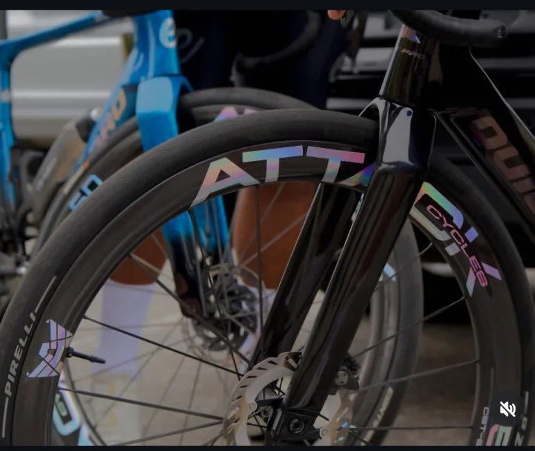 Close-up of ATTACKCYCLES rims and tires on bikes racked before a race.
