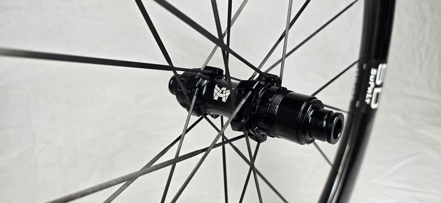 Carbon spokes radiating from an ATTACKCYCLES hub, photographed against a white backdrop.